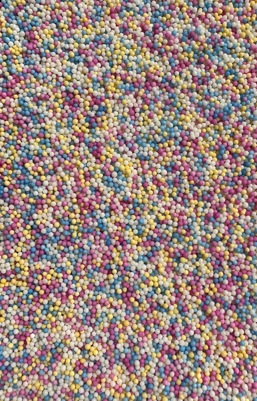 Pastel round sprinkles light yellow, blue pink and white 